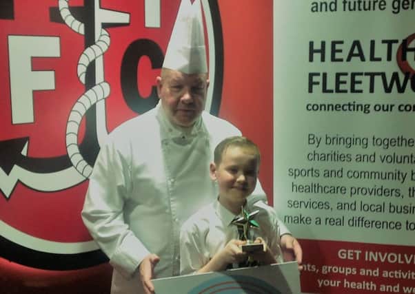 Alfie Hall of Shakespeare Primary School is presented with the title of Fleetwood Young Chef of the Year by chef Harry Lomas.