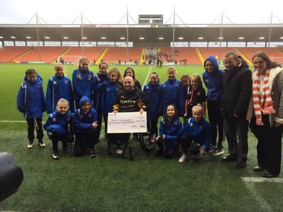 The cheque presentation at Bloomfield Road