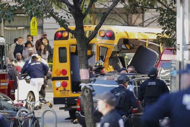 Authorities respond near a damaged school bus in New York. A motorist drove onto a busy bicycle path near the World Trade Center memorial and struck several people on Tuesday police and witnesses said