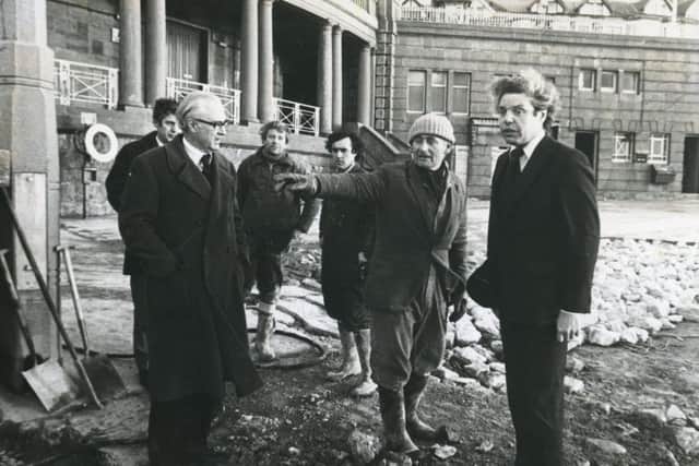 Mr Peter Blaker (left) and Mr Norman Miscampbell talk to workmen during their tour of flood damage