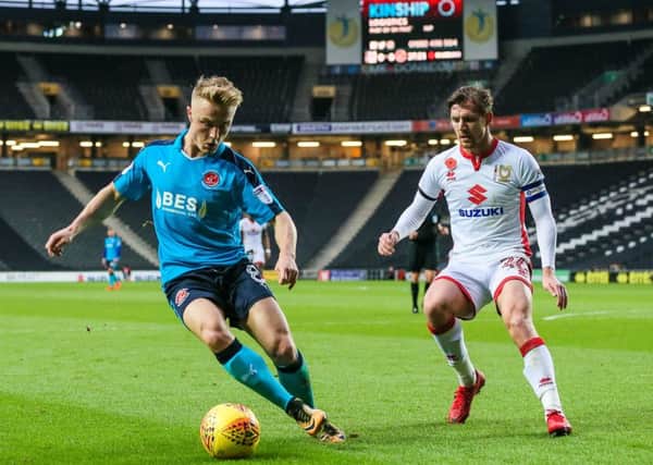 Fleetwood Town's Kyle Dempsey competing with Milton Keynes Dons' Alex Gilbey