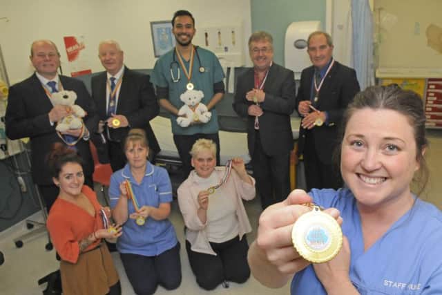 West Lancs Freemasons have donated medals to children in A&E at Blackpool Victoria Hospital.  Back row L-R are Duncan Smith, Harry Cox, Dr Jomel George, Hugh Mett and Peter Gunn.  Front row L-R Lauren Codling from Blue Skies, staff nurse Jacqui Smith, family liason Joanne Gunn and staff nurse Angela Mason.