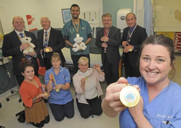 West Lancs Freemasons have donated medals to children in A&E at Blackpool Victoria Hospital.  Back row L-R are Duncan Smith, Harry Cox, Dr Jomel George, Hugh Mett and Peter Gunn.  Front row L-R Lauren Codling from Blue Skies, staff nurse Jacqui Smith, family liason Joanne Gunn and staff nurse Angela Mason.