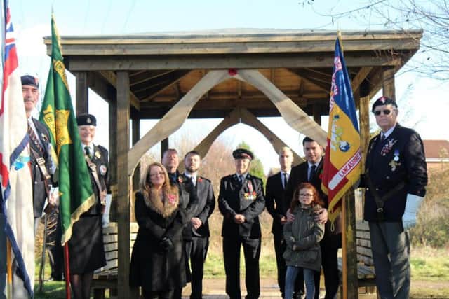 Representatives of Blackpool and the Fylde College, Wilmott Dixon join standard bearers at the dedication of the replica of the Changi Gate at the Fylde Arboretum in Bispham