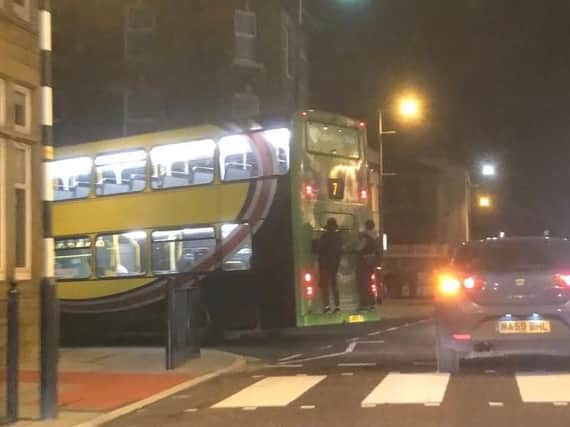 The picture appears to show two people clinging on to the back of the bus. Photo: Twitter\JamesClancy1