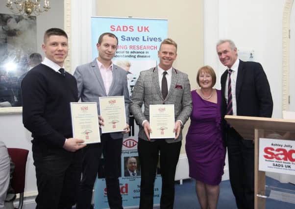 Andrejs Bespalov, Georgijs Kadakov and JamesGrimston receive lifesaver awards from SADS after saving colleague Nathan Davies