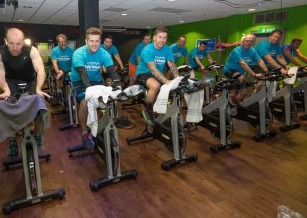 Ben Cross (left) and friends taking part in a 16 hour spin bike ride in Village Gym to raise money for Brian House.