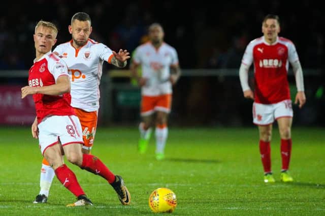 Fleetwood Town's Kyle Dempsey vies for possession with Blackpool's Jay Spearing