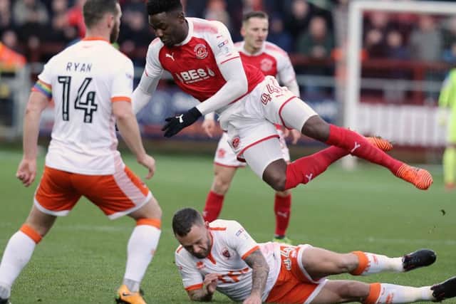 Fleetwood Town's Devante Cole is tackled by Blackpool's Jay Spearing