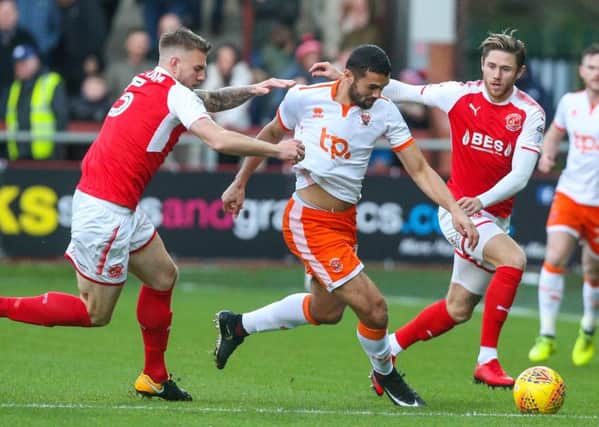 Blackpool's Colin Daniel battles with Fleetwood Town's Ashley Eastham and Wes Burn