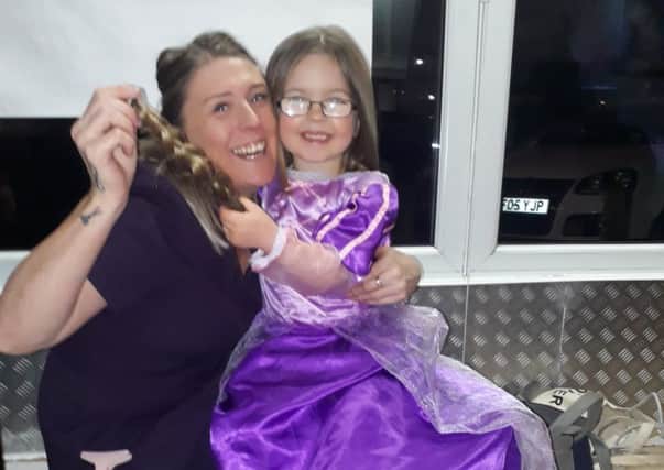 Hairdress Kymi Taylor with five year old Fleetwood youngster Phoebe Colclough.
