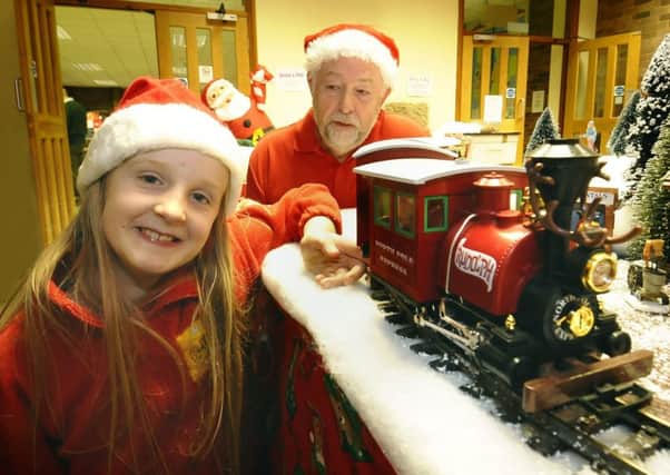 G-Wizz model railway exhibition organiser Allan Judd with grand-daughter Gabby Neild at a previous Christmas display