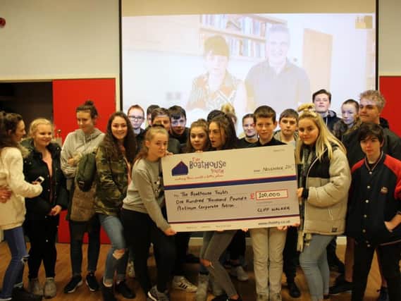 Youngsters from The Boathouse Youth project get their cheque all the way from Uruguay and Cliff and Bev Walker