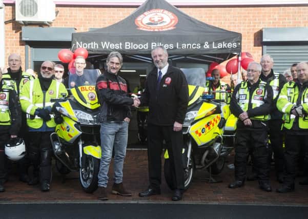 Paul Brooks shakes hands with superbike World Champion Carl Fogarty at the opening of the blood bikers new HQ
