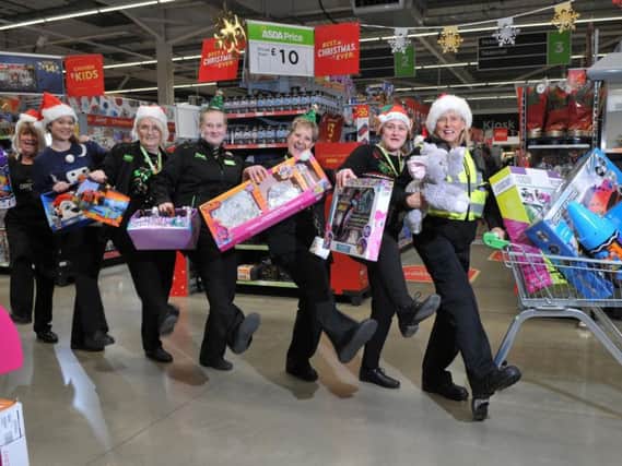 PCSO Linda Stackhouse and staff from Asda Fleetwood, who are helping out the Wish Tree Appeal, a charity scheme to helps mums and kids in refuges on the Fylde coast