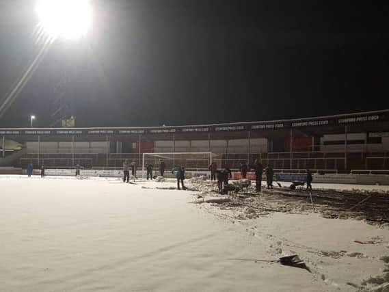 Hereford fans clearing the snow at Edgar Street. Photo credit Hereford FC.
