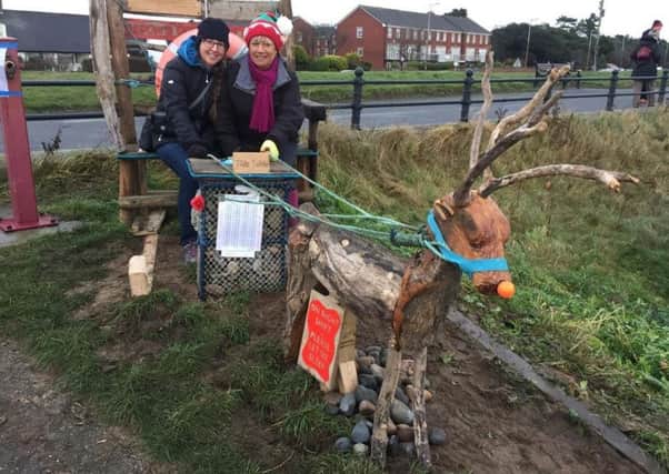 Michelle Stannard and Meg Green of the Friends of the Estuary on the 'Rudolph and Sleigh' erected by the Friends at Seafield Road, Lytham