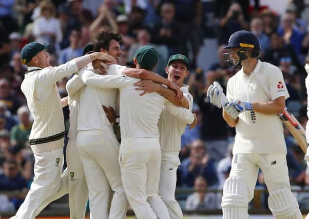 Australia celebrate the final wicket of Chris Woakes to win the Ashes at the WACA in Perth