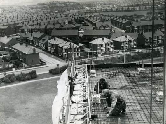 Men working on the high rise flats at Queenstown, Layton, in 1963