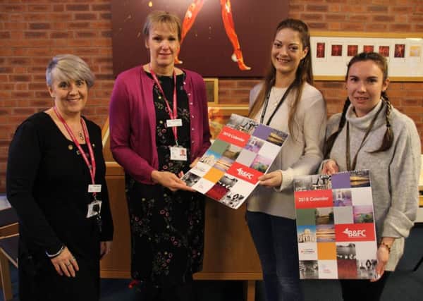 Vicki Costigan and Jackie Bullock, from Trinity Hospice, and students
Vicki Norris and Claire McGurk from B&TFC

Handing over the calendars produced by students to raise money fro hospice
