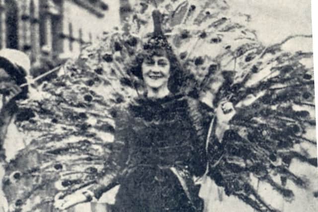 A woman, named only as Mrs Topping, in peacock feathers for the carnival in 1923