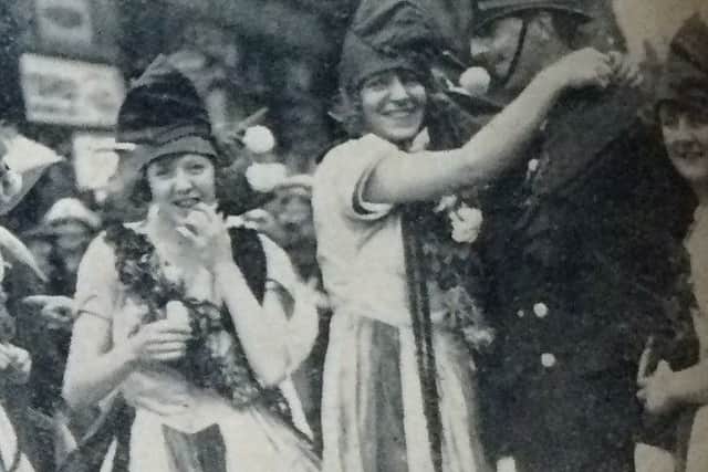 A happy constable laughs with revellers at the carnival in 1923, which attracted two million people