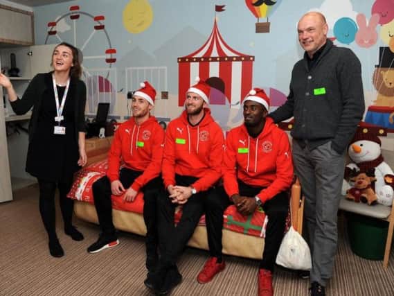 Fleetwood Town players Conor McAleny, Chris Neal, Jordy Hiwula and head coach Uwe Rosler got in the festive spirit when they handed out gifts at Brian House Children's Hospice.