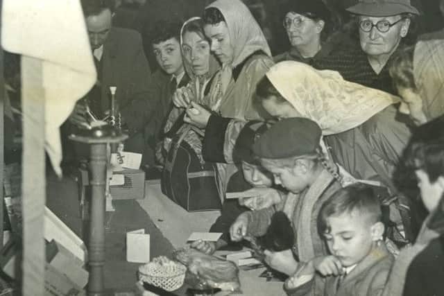 A busy scene at one of the stalls at the Willows Roman Catholic Church Christmas fair in the Church Hall, Kirkham, in 1954