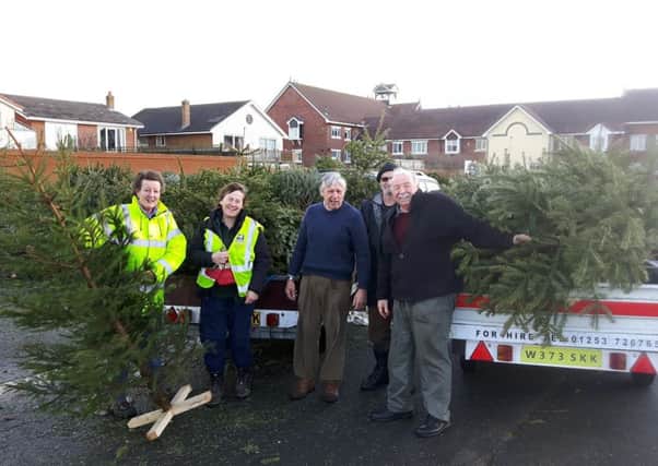 Coun Tony Ford (right) and Coun Carol Lanyon wth some of the trees collected after last Christmas