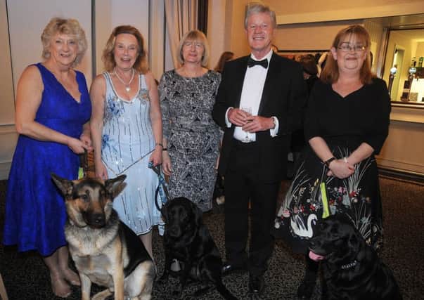 The Guide Dogs movement in Blackpool marked its diamond anniversary with a celebration dinner at the Cliffs Hotel.
 From left: Sue Ballantyne, Barbara Clarkson, Marj Boyer, Andy Guiel and Cheryl Johnson, with guide dogs Bamber, Fliss and Thelma