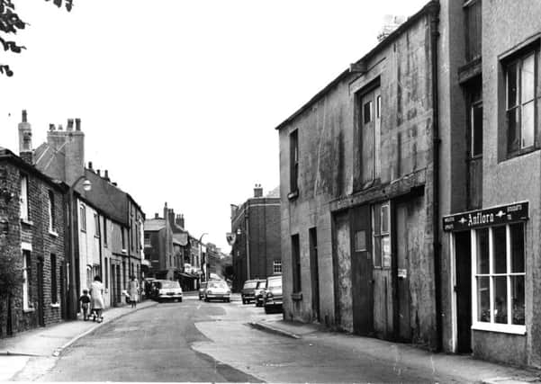 Blackpool Old Road, Poulton, in 1968, showing a very different view than today where a one way traffic system now operates. 
This picture looks towards The Market Place and Queens Square with The Bull right of centre