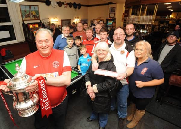 The FA Cup comes to the Strawberry Gardens pub.  Pictured is Ron Miller with the cup and punters behind.