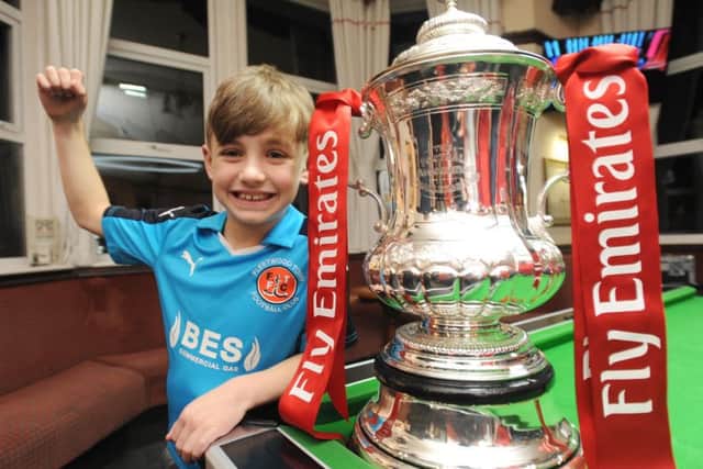 The FA Cup comes to the Strawberry Gardens pub.  Pictured is Ollie Melvin-Bainbridge with the cup.
