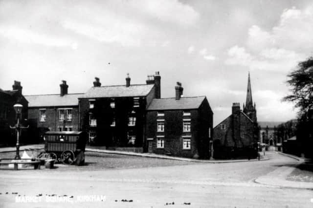 The Market Square, Kirkham in 1914 was  bounded by cottages, today these have been replaced by flat roofed two storey  shops and offices.