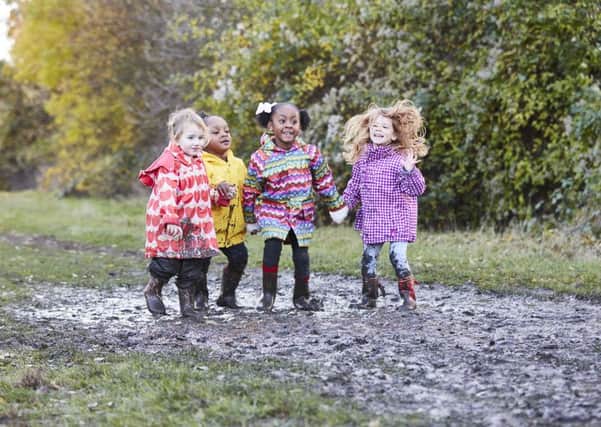 Children take part in a Muddy Puddle Walk to raise money for Save the Children