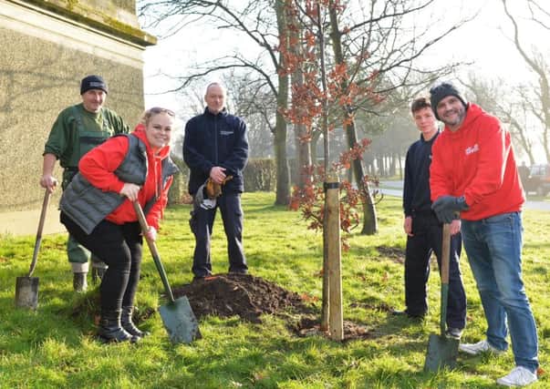 Hayley and Scott with Blackpool Council staff planting a tree in Stanley Park on behalf of Winter Gardens