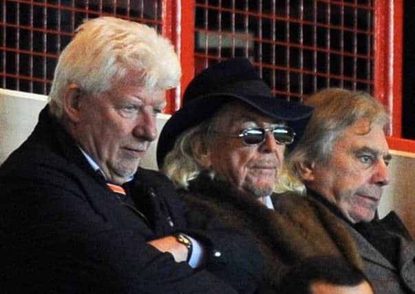 Owen Oyston (centre), at Charlton three weeks ago, has continued to attend games since putting the club up for sale