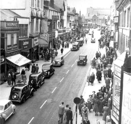 Church Street, looking towards St John's Church in the 1950s - when traffic still moved freely and parking was available outside the shops