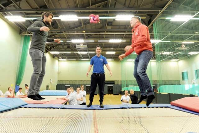 Blackpool players Andy Taylor and Jim McAlister have a go on the trampoline