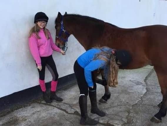 Young people working with horses at Midgeland Riding Centre