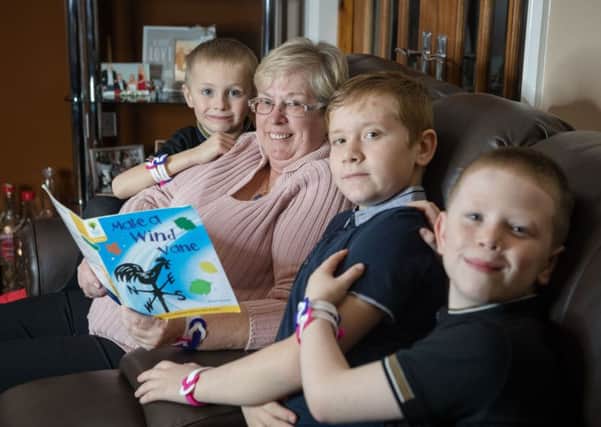 Blackpool cancer survivor Pam Lindsay and her grandchildren Jake Addison (six), Mason Lindsay (11) and Jamie-Jay Lindsay (7) wear Cancer Research UK Unity Bands ahead of World Cancer Day. Money raised through donations for the Unity Bands helps fund the charitys life-saving research so people like Pam can go on enjoying the things they love.
Pic: Julie Lomax