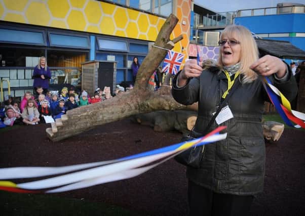 Former teaching assistant Gaynor Parkinson, who worked at the school for 32 years, cuts the ribbon to officially open the area