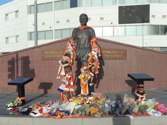 Scores of tributes have been left by Jimmy's statue since news of his death on Monday