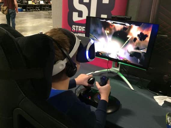 A young enthusiast enjoys a 3D game at Replay Events Manchester  show