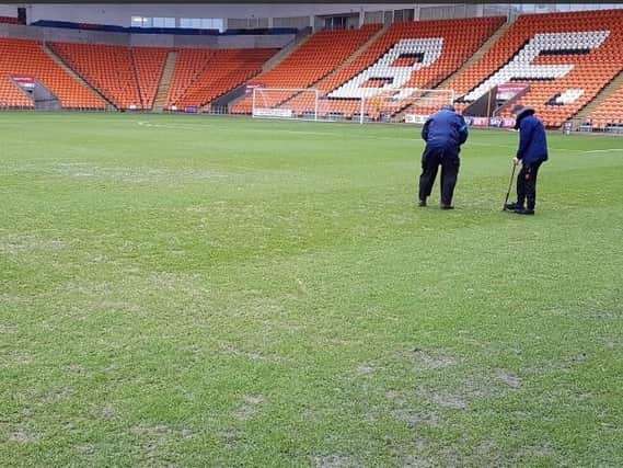 Groundsmen working on the pitch