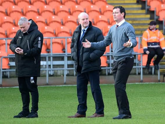 Gary Bowyer in conversation with the officials before they took the decision to call the game off