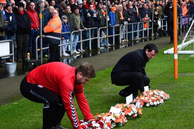 Karl Robinson joins Gary Bowyer in laying a wreath in front of the Armfield Stand
