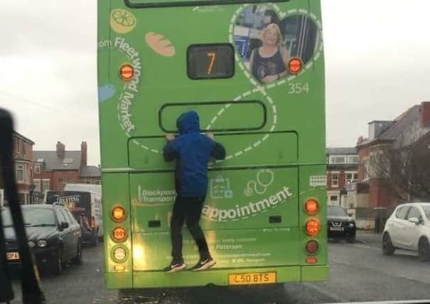 Days after transport bosses warned of youngsters on the Fylde coast putting their lives at risk  and breaking the law  by jumping on the back of buses while they drive down the street, another child has been pictured taking part in the dangerous craze.
