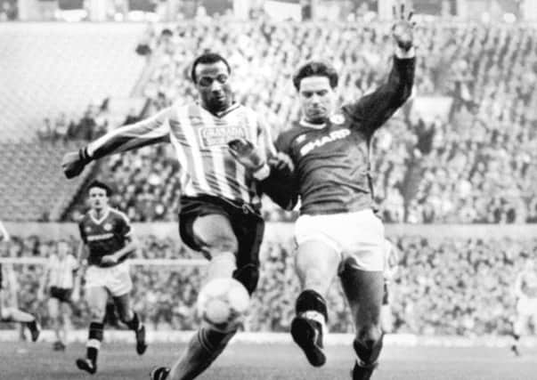 Cyrille Regis in action for Coventry battling with Manchester United's John Sivebaek (photo: PA)