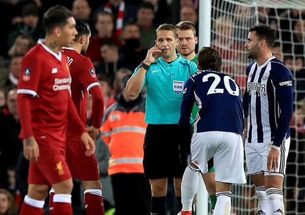 Referee Craig Pawson disallows a West Bromwich Albion goal against Liverpool after a discussion with the Video Assistant Referee